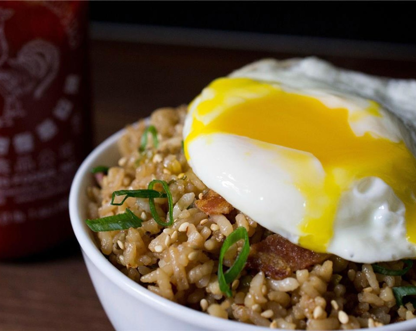 step 8 Place a fried eggs on top of each bowl of breakfast fried rice and garnish with the remaining sliced scallion. Serve immediately, being sure to break the yolk over the rice so it can act like a sauce. Serve with Sriracha (to taste) sauce if desired.