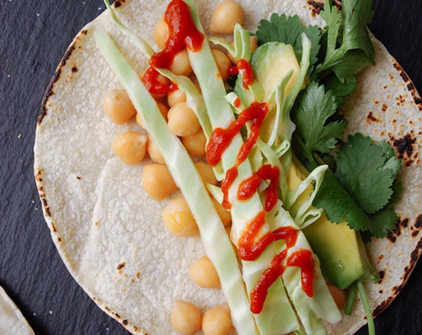 step 3 Layer your tacos with Chickpeas (1 1/2 cups), shredded cabbage, avocado and Fresh Cilantro (to taste). Top with Mineral Salt (to taste), Sriracha (to taste) and a squeeze of lime.