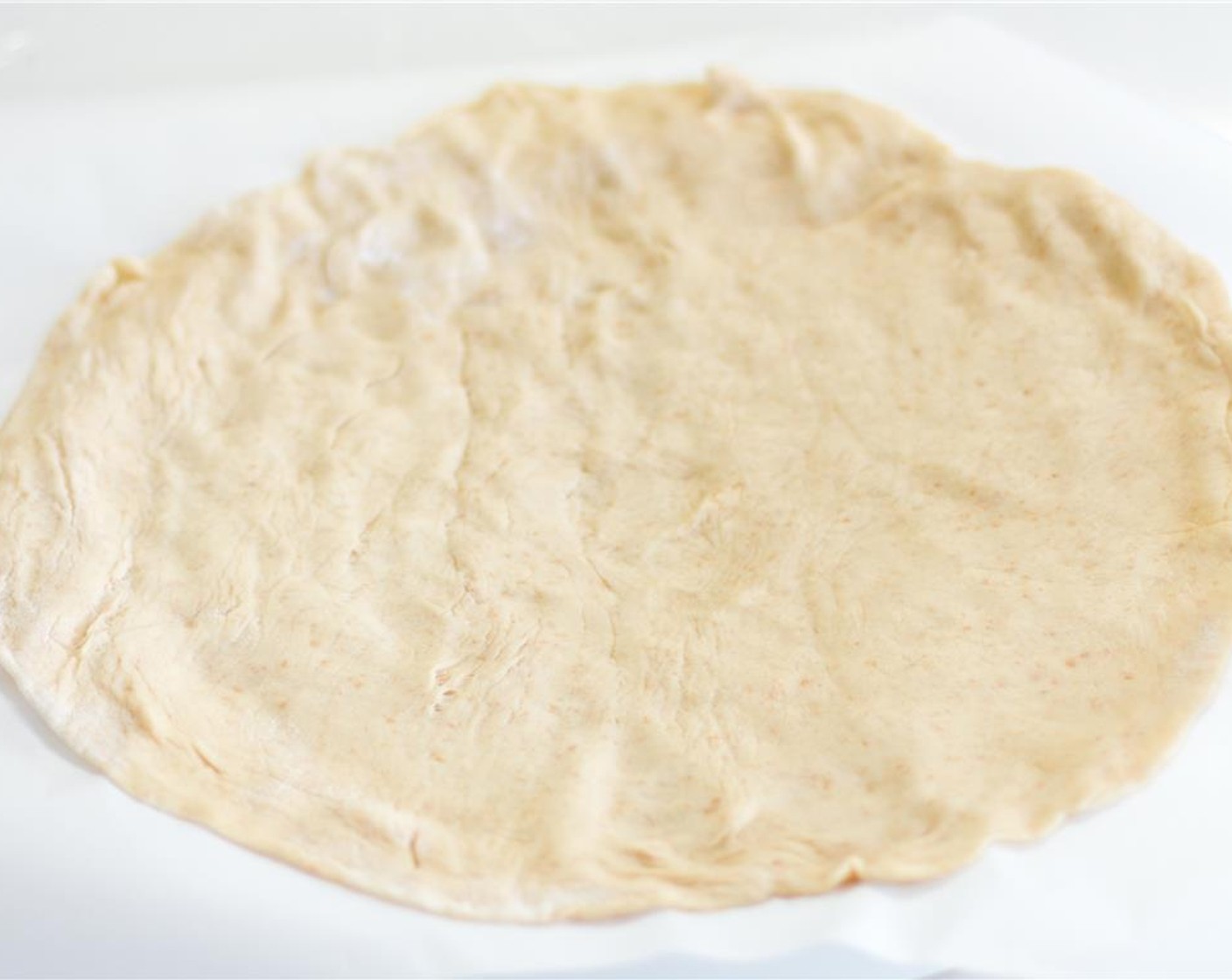 step 1 Roll out 9-inch Pie Crust (1). Line a cookie sheet with parchment paper. Then place the pie crust on the sheet and set aside.