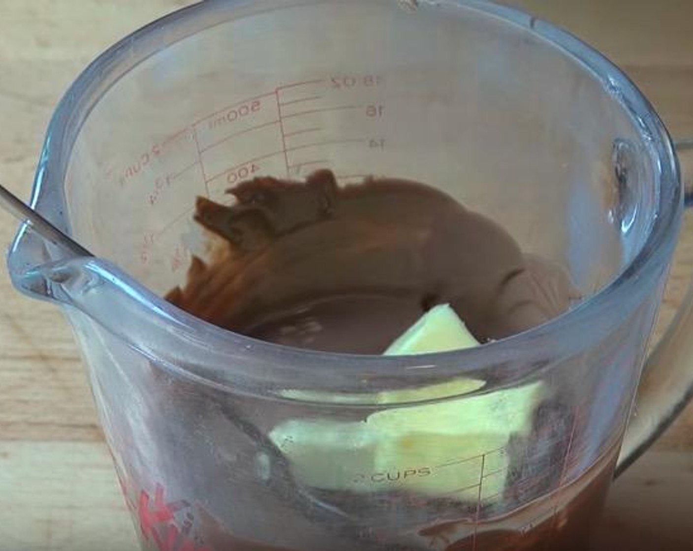 step 5 Add butter to the melted chocolate and stir to combine.