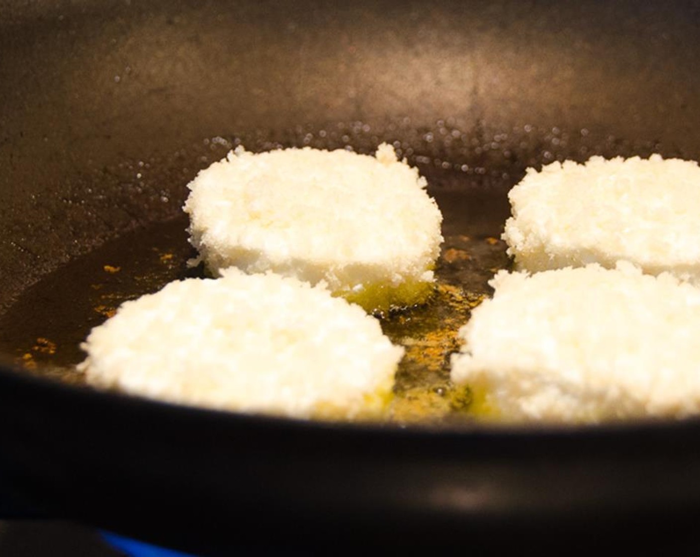 step 8 Heat the Olive Oil (1/4 cup)  in a heavy skillet over medium high heat. Add the goat cheese rounds and cook for 1-2 minutes on each side until just browned.