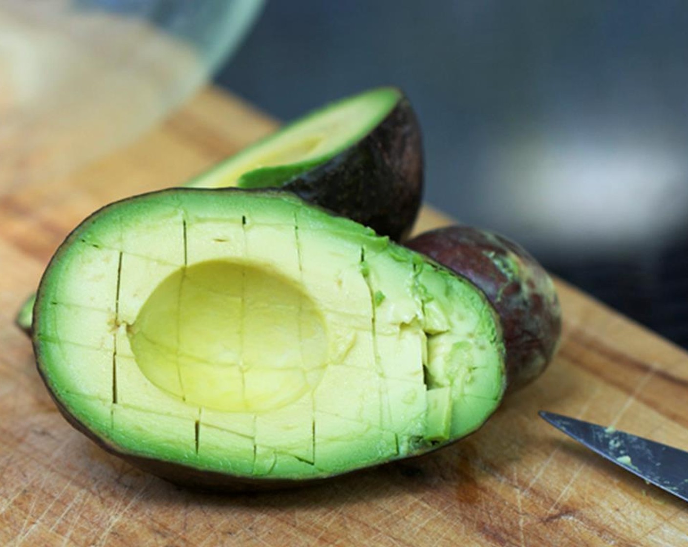 step 1 Cut the Avocados (5) in half and pit them. Score it with a knife.