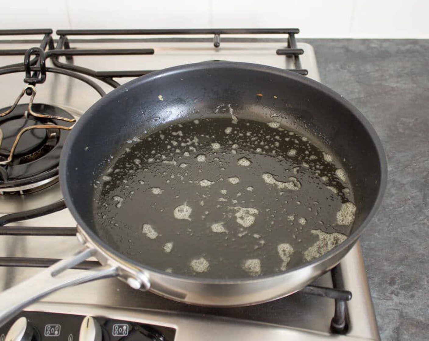 step 5 Get your pan nice and hot. Not so hot that it burns the butter, but hot enough that the batter starts bubbling ever so slightly when you pour it in. Add a small knob of Unsalted Butter (to taste) and allow to melt. Then swill it around to cover the whole pan.