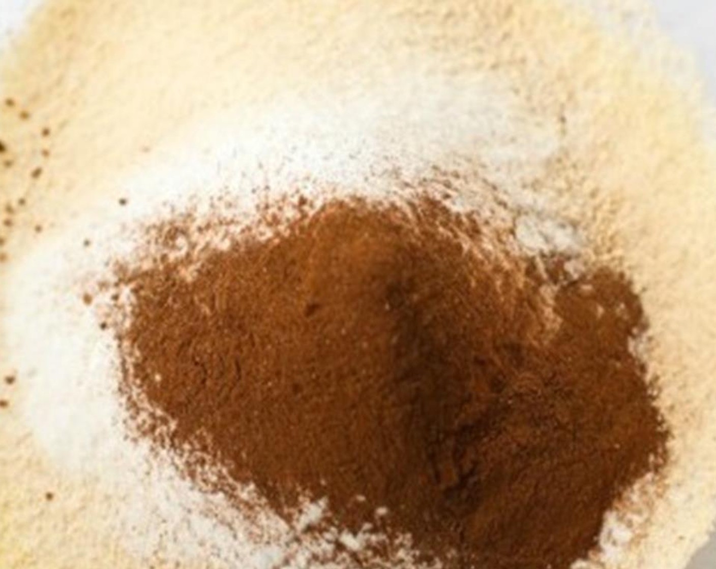 step 3 In a large bowl, sift Coconut Flour (1 cup), Almond Flour (1 cup), Baking Powder (1 tsp), Baking Soda (2 tsp), and Simply Organic Cinnamon, Ground (1 tsp).