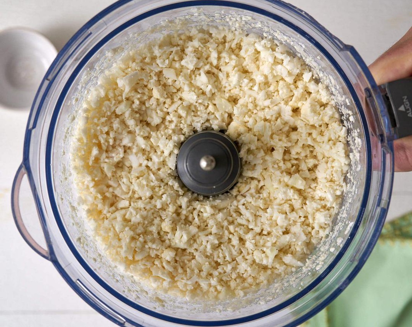 step 1 The quickest way to "rice" your Cauliflower (1 head) is to toss it into a food processor and blitz it for less than a minute until it's the size of rice. Otherwise, go old school and use a cheese grater.