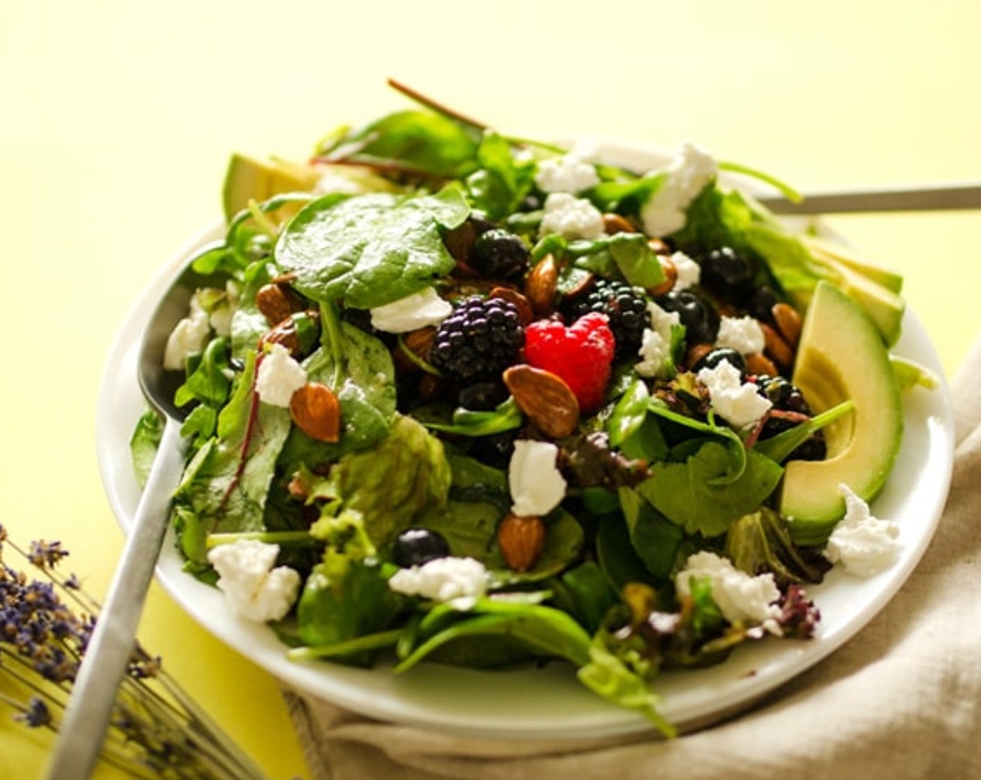 step 2 In a large bowl, gently toss together the Salad Greens (3 handfuls), Fresh Mixed Berries (1 cup), Almonds (1/2 cup), Goat Cheese (1/4 cup), and vinaigrette. Top with Avocado (1/2). Serve and enjoy!