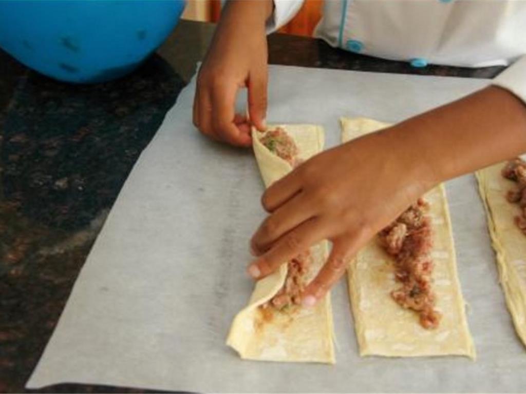 Step 5 of Sausage Bites With Maple Lemon Sauce Recipe: Fold the long sides of puff pastry over to meet in middle and press seam to seal.