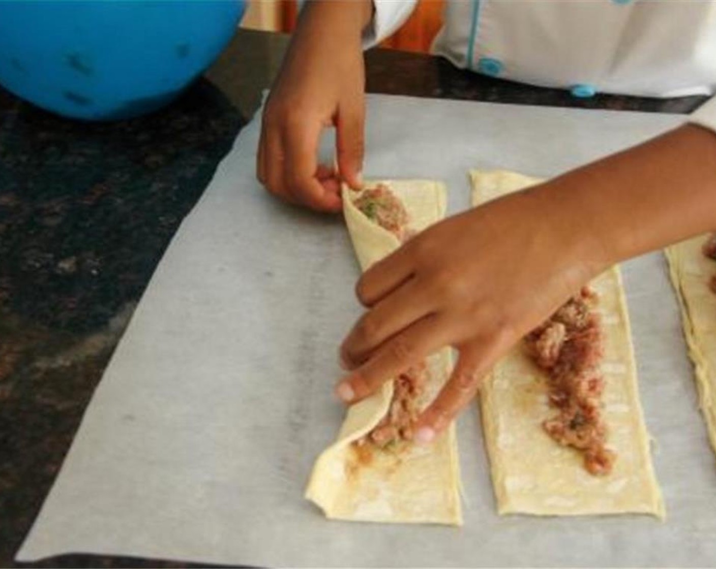 step 5 Fold the long sides of puff pastry over to meet in middle and press seam to seal.