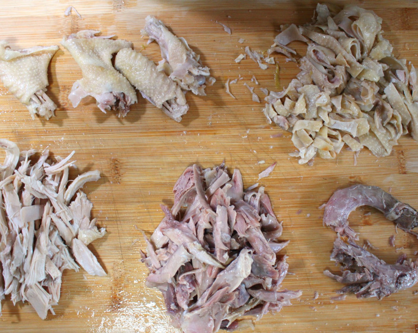 step 8 Remove the meat from the bones, separately remove the skin, wings, and neck. Optionally you can keep the white and dark meats separate.