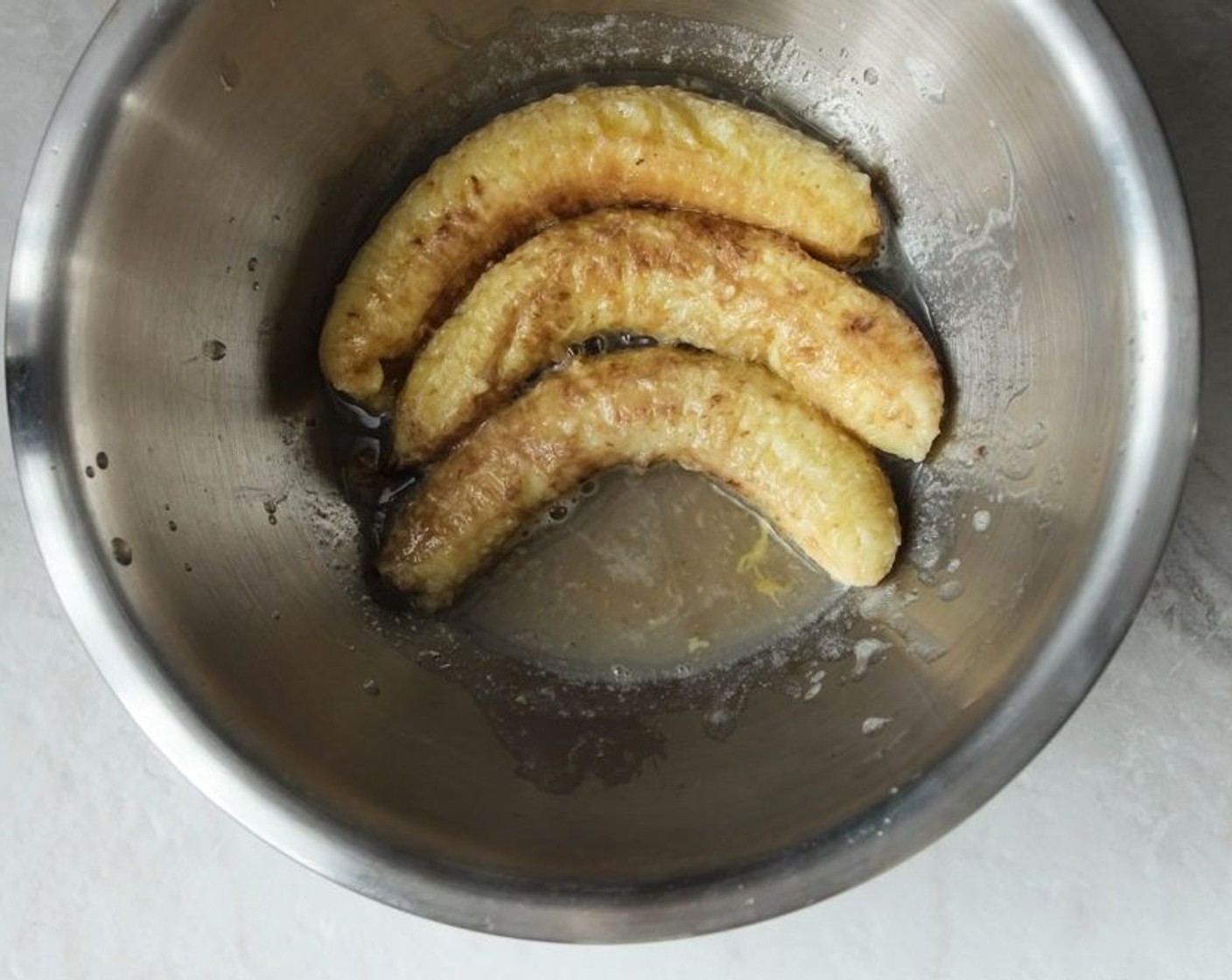 step 7 Once the banana has cooled, mash it up and add it to the wet ingredients. Squeeze all the liquid out from the banana skins and mix it into the wet ingredients as well, this will be the naturally sweetened banana extract!