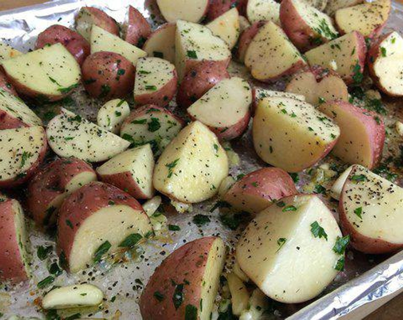 step 2 Place your Baby Red Potatoes (6) and lay them on the same baking sheet you cooked your bacon, add Olive Oil (as needed) and a few spoons of bacon fat, and coat with Coarse Salt (to taste), Ground Black Pepper (to taste), Fresh Parsley (to taste), and Garlic (to taste).