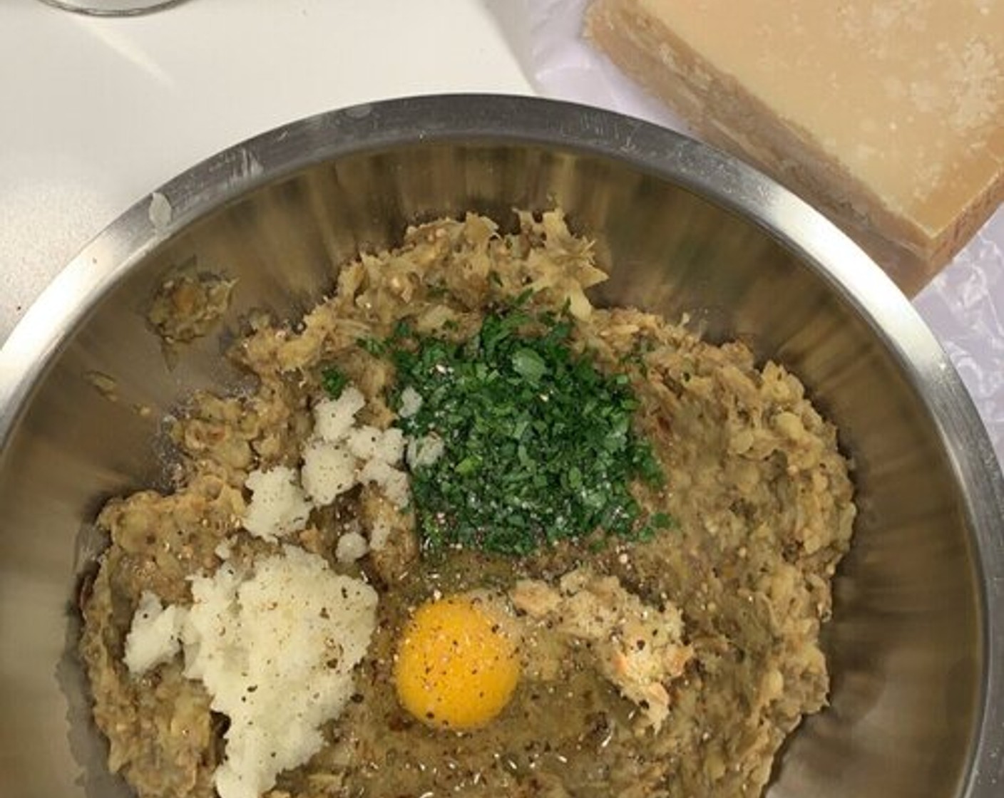 step 5 Transfer the eggplant mixture to a bowl along with the Fresh Parsley (1/4), Eggland's Best Classic Egg (1), Parmesan Cheese (to taste), Breadcrumbs (to taste), Crushed Red Pepper Flakes (1/2 tsp), Pine Nuts (4 Tbsp), Salt (to taste), Ground Black Pepper (to taste), and mix until combined.  Adjust the breadcrumbs and seasoning as needed, and don’t over mix the polpette or it won’t hold.