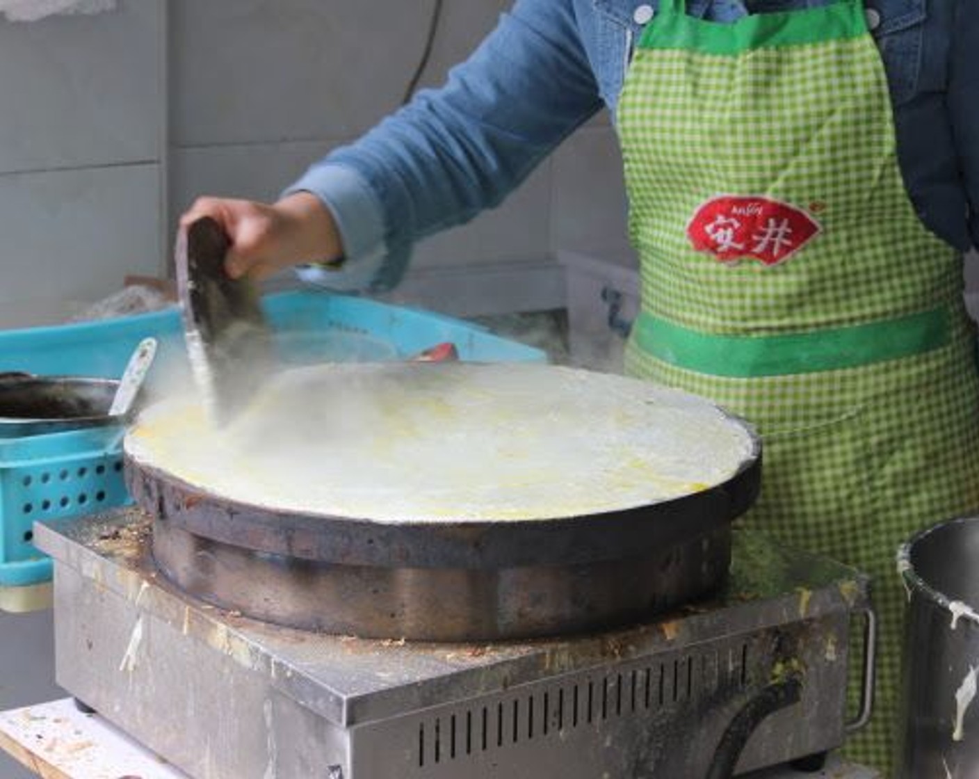 step 3 Quickly spread the dough with a paddle to achieve a consistent thickness (yours might be slightly smaller than this).