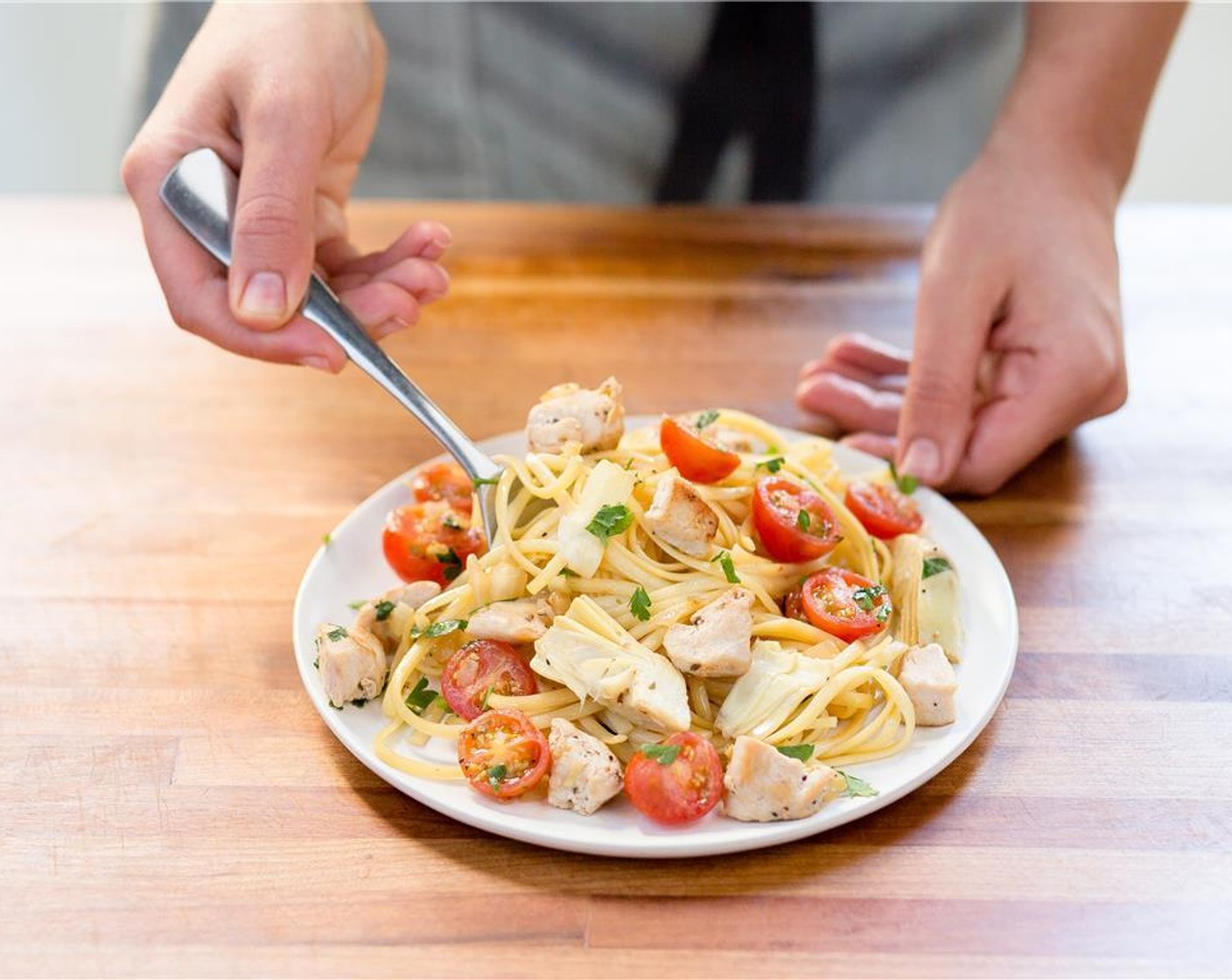 step 7 Place the Greek chicken pasta in the center of 2 plates.