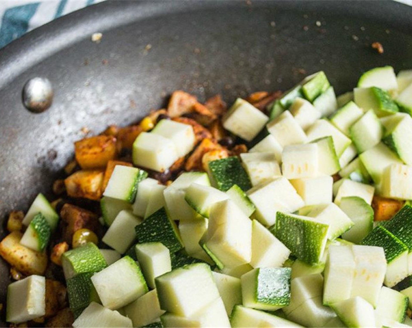 step 4 Add Organic Black Beans (1/2 cup), Zucchini (1), and Mild Salsa (2 Tbsp) to potato and corn mixture, stir to combine and continue cooking another 4 to 5 minutes, or until potatoes and zucchini are cooked to your liking.