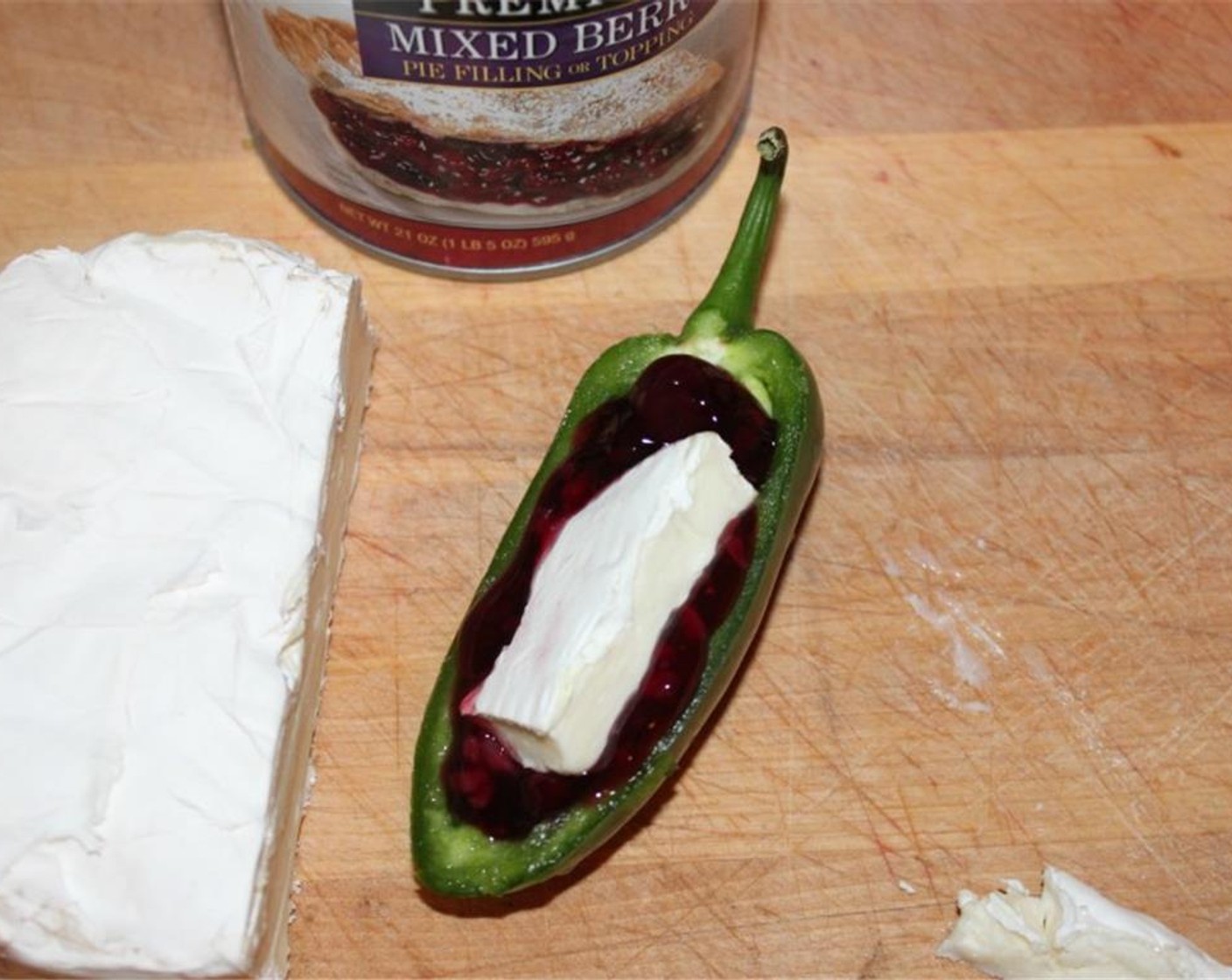 step 2 Fill each pepper with a scoop of Mixed Berry Pie Filling (1 can) and a slice of Brie Cheese (8 oz).