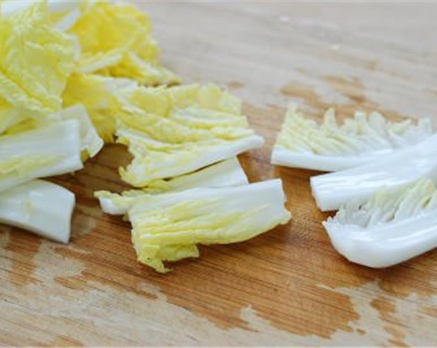 step 3 Cut the Napa Cabbage (2 1/2 cups), Korean Radish (3 oz), and Carrot (1) into bite size pieces. Thinly slice the Onion (1/2) and Mushrooms (2). Cut the Scallion (1 bunch) in similar lengths. Set aside.