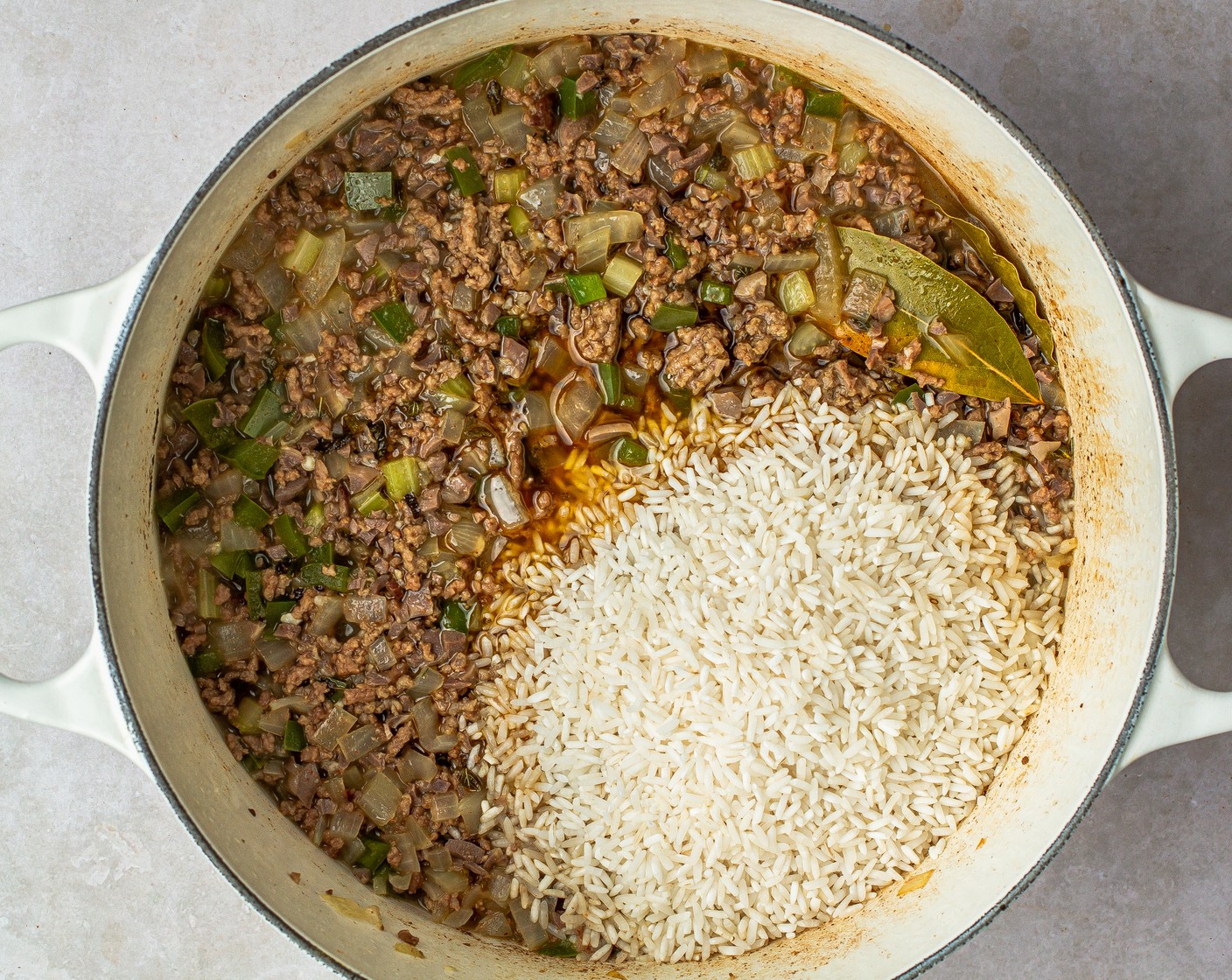 step 6 Stir in the Long Grain White Rice (1 1/4 cups) and Bay Leaves (2). Bring to a boil, then reduce heat to a simmer and cover for 12-15 minutes or until rice is cooked.