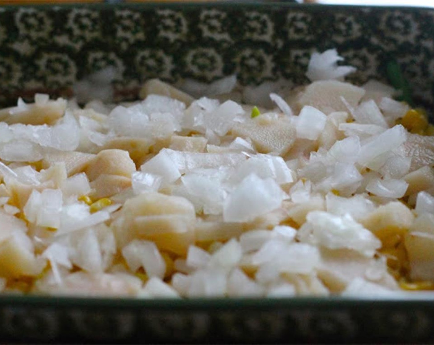 step 4 In a 9-inch casserole pan, layer the green beans, corn, water chestnuts and chopped white onion.