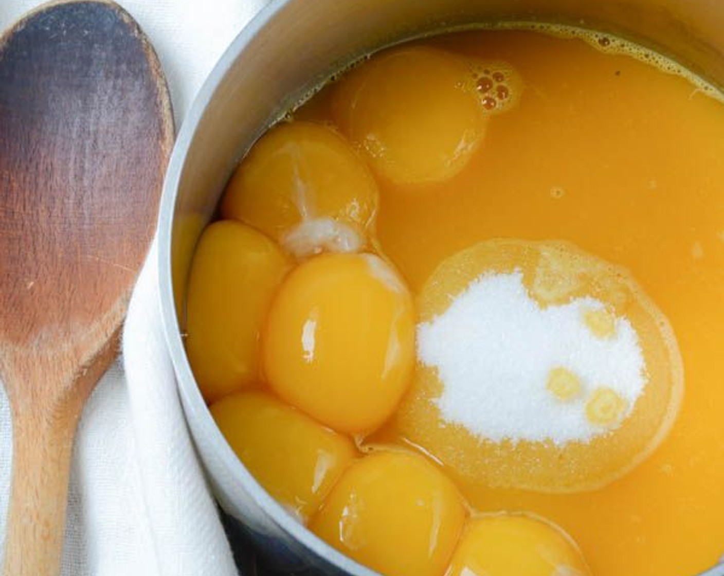 step 15 In a small saucepan, combine the Farmhouse Eggs® Large Brown Eggs (7), passion fruit juice and Granulated Sugar (1 cup). Stir constantly over medium heat until the sugar dissolves and the sauce thickens enough to coat the back of a spoon.