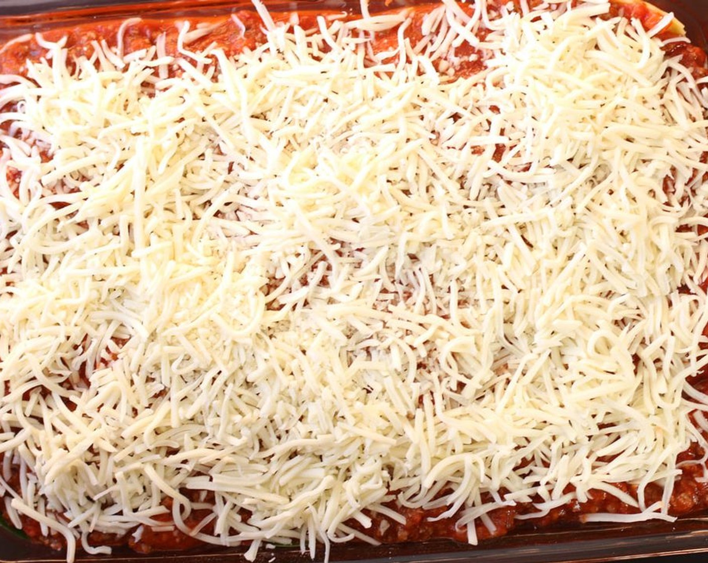 step 5 Sprinkle remaining Shredded Mozzarella Cheese (1 cup) evenly over top, and sprinkle with Grated Parmesan Cheese (1/3 cup).