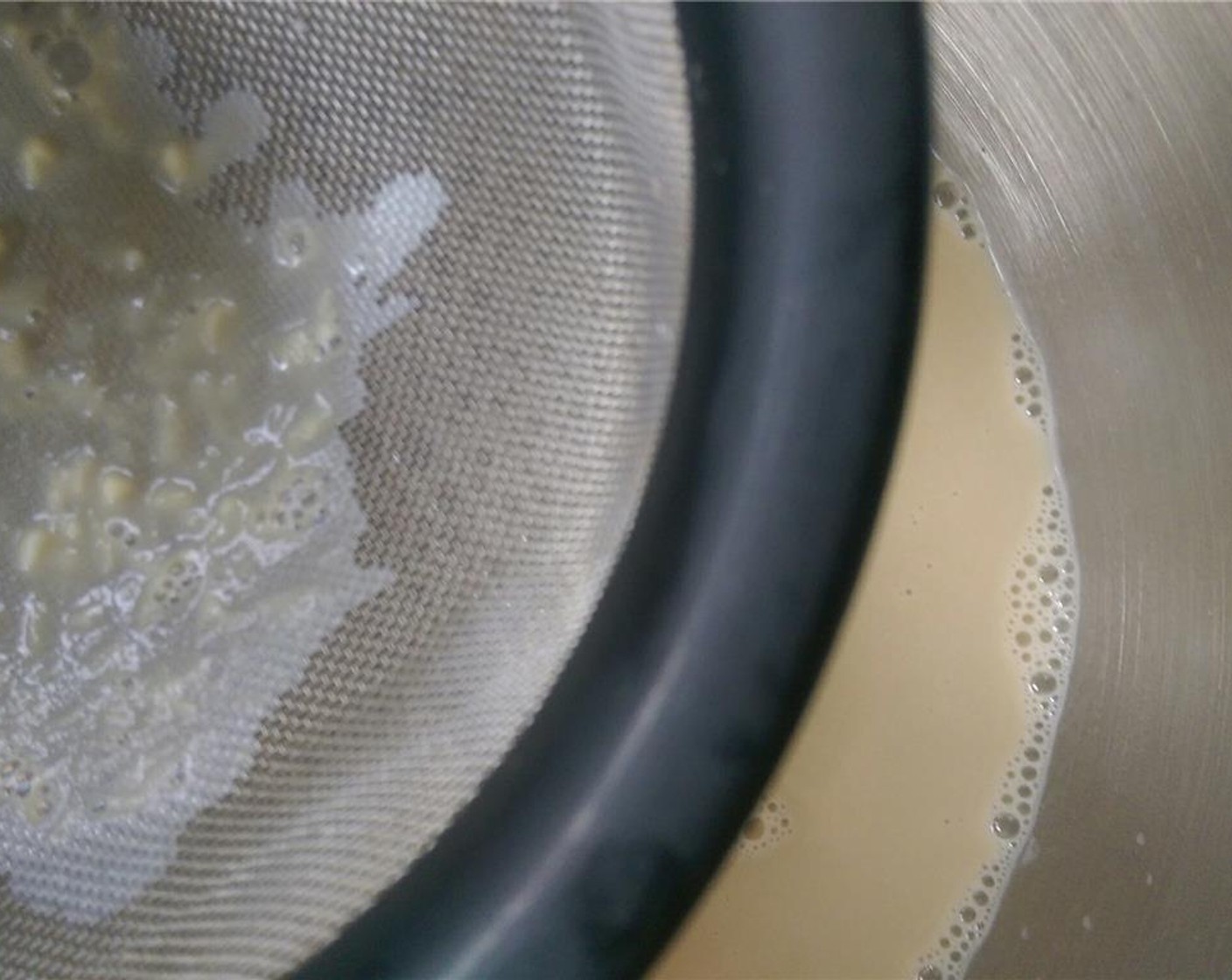 step 6 Pour custard over a strainer into a bowl. This will collect any bits of egg that didn't incorporate. Cover bowl with plastic wrap and refrigerate 4-5 hours until completely chilled.