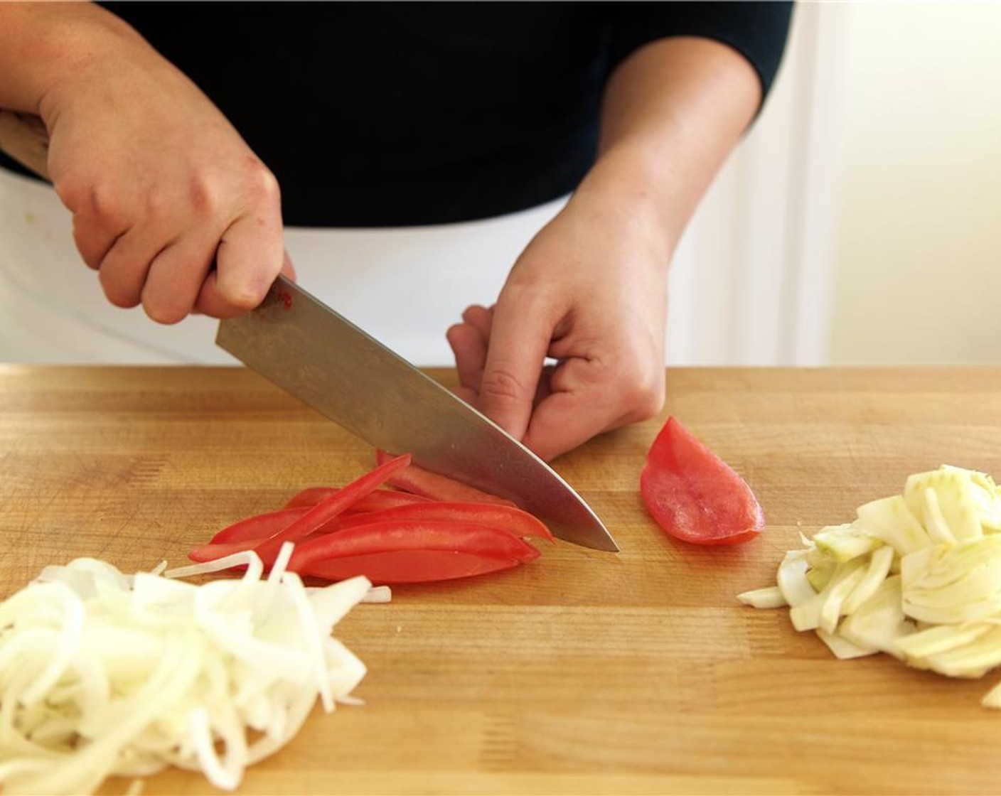 step 3 Cut the Roma Tomato (1) lengthwise into four wedges. Scoop out the seeds and discard. Slice tomato into thin, long, half inch strips, and set aside.