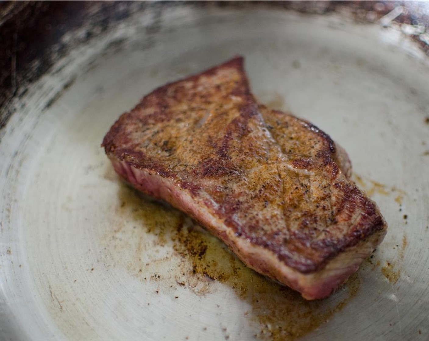 step 4 Add the steak to the hot frying pan and grill each side for 4 minutes (or longer if you want it more cooked). After 4 minutes, add the shallots.