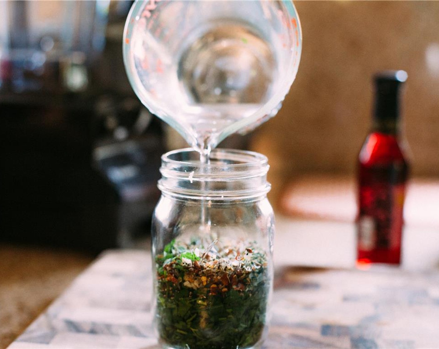 step 6 Pour the Water (1/4 cup) and Sunflower Oil (1 Tbsp) into the jar.