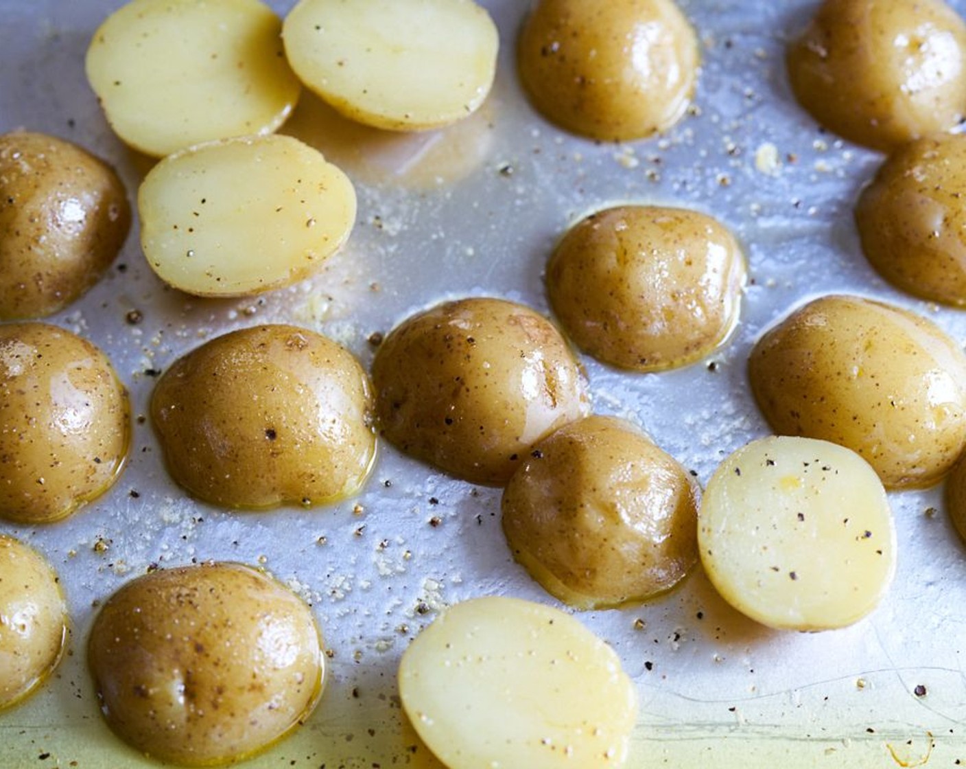 step 5 Remove foil and allow potatoes to cool just enough so you can handle them. Flip them over to cut side up and let the steam escape so the cut surface of the potatoes dries. If there is any water remaining on the pan, dab it off with a kitchen towel.