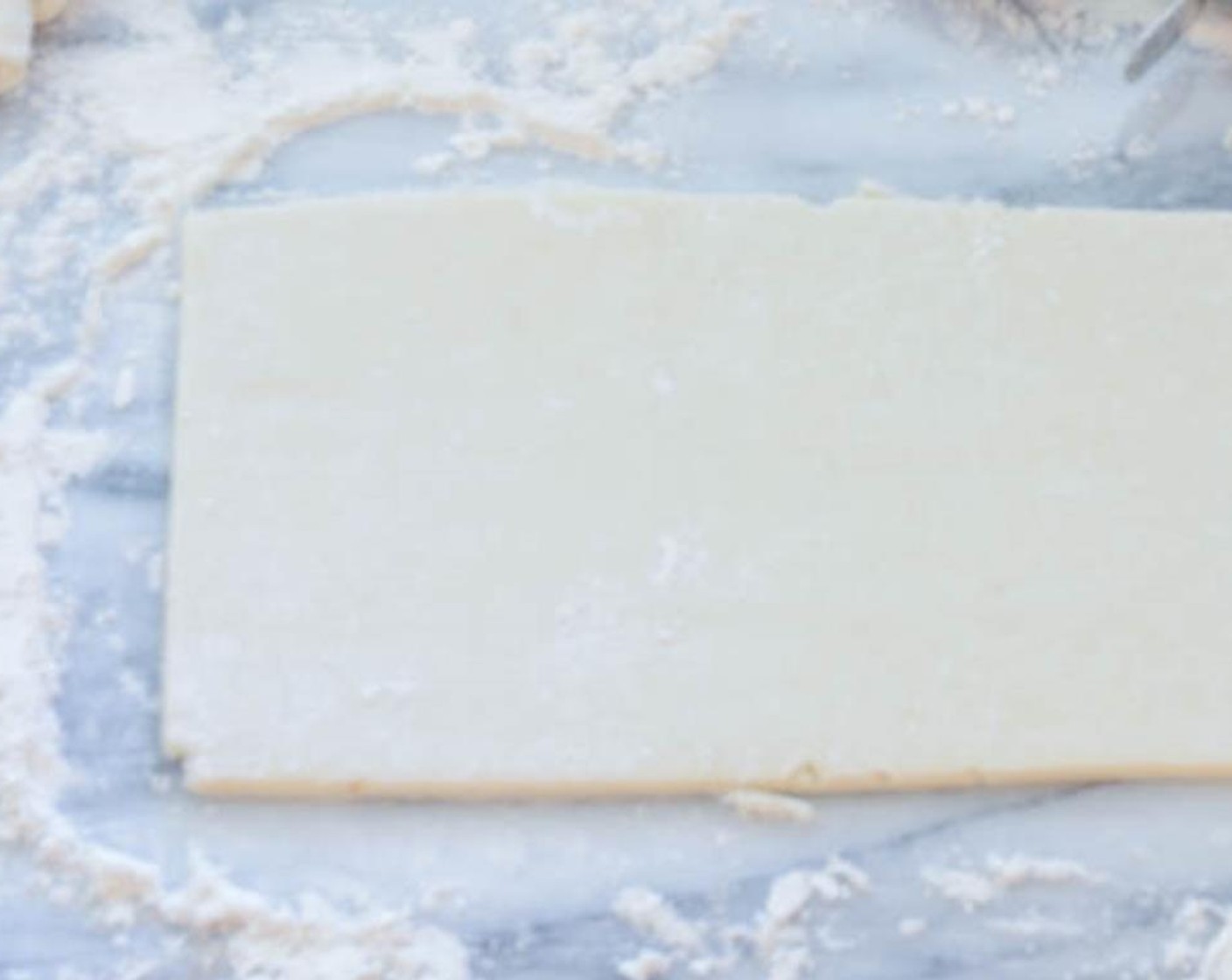 step 9 Generously flour your work surface. Working with one piece of chilled dough at a time, place the dough on the floured surface. Roll the dough into a rectangle about 12 x 5 inches. Use a pizza cutter to even up the sides and edges.