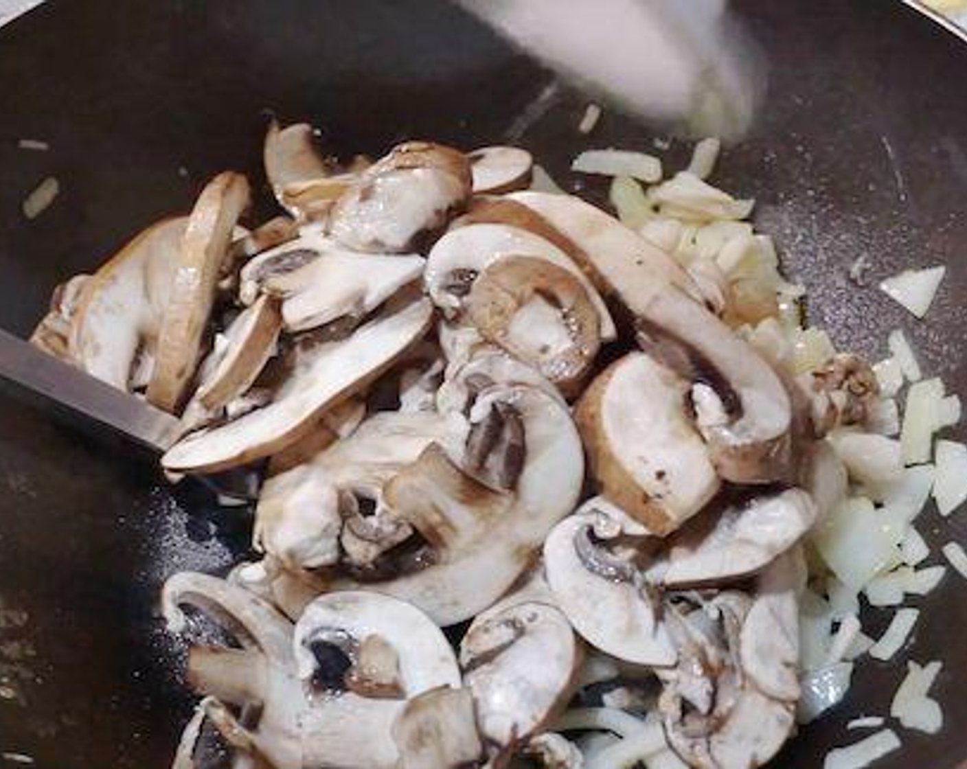 step 5 Add the Brown Mushrooms (3 1/3 cups) and Beech Mushrooms (2 2/3 cups). Season with Salt (to taste) and Ground Black Pepper (to taste). Continue stir-frying till most of the water from mushrooms has evaporated. Set aside.