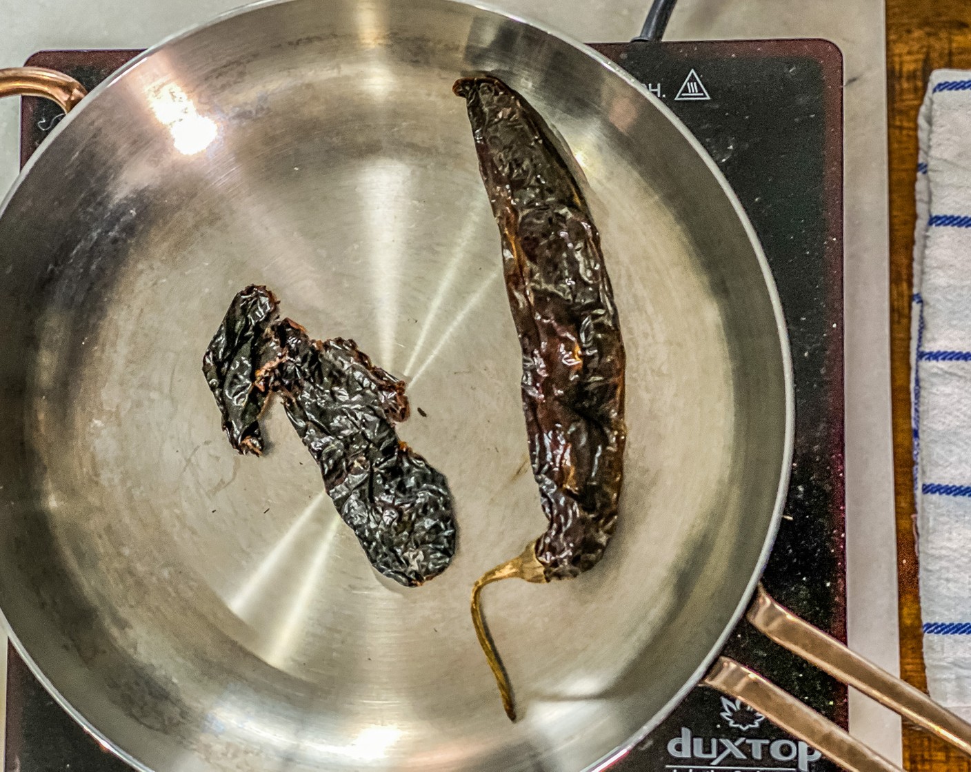 step 1 Heat a large skillet over high heat for 2 minutes. Add the Guajillo Chiles (2) and toast for 15 seconds on each side.