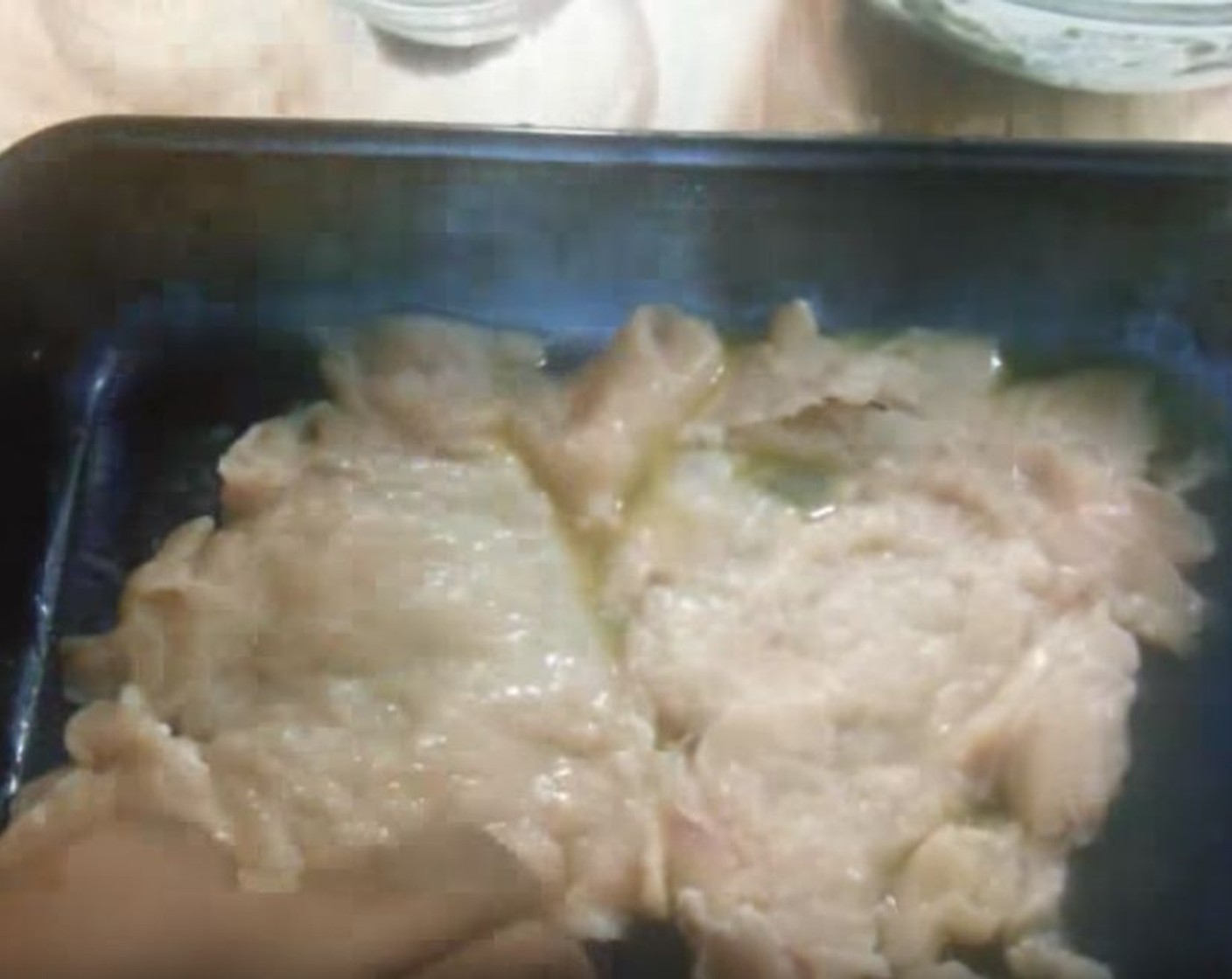 step 4 Into a casserole pan, add Butter (2 Tbsp). Lay two halves of the Chicken Breasts (2) on top.