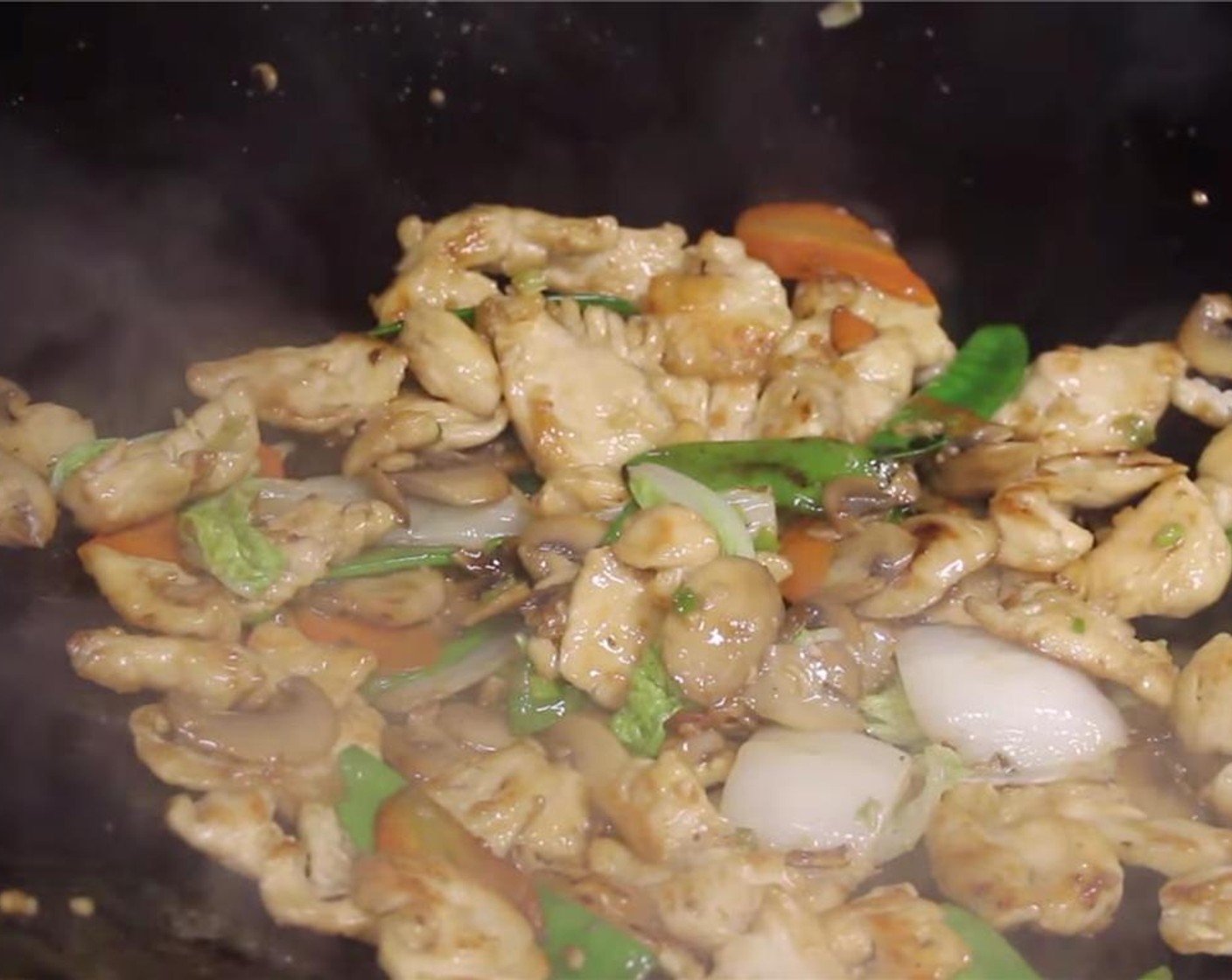 step 14 Add back in the partially cooked chicken breast and napa cabbage leaves. Continue to stir fry for 15 to 20 seconds.