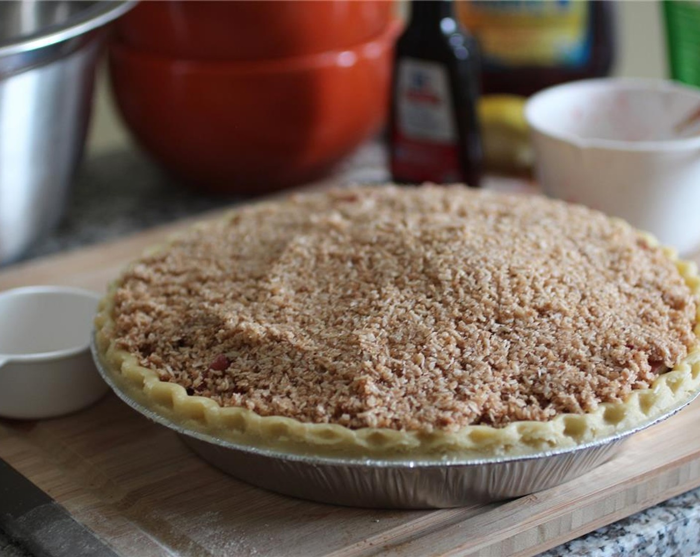 step 6 Top the fruit with the coconut mixture, making sure the pie is evenly covered with the crisp topping. Cover the pie with tin foil and poke a couple holes in it for venting, and bake for 20 minutes.