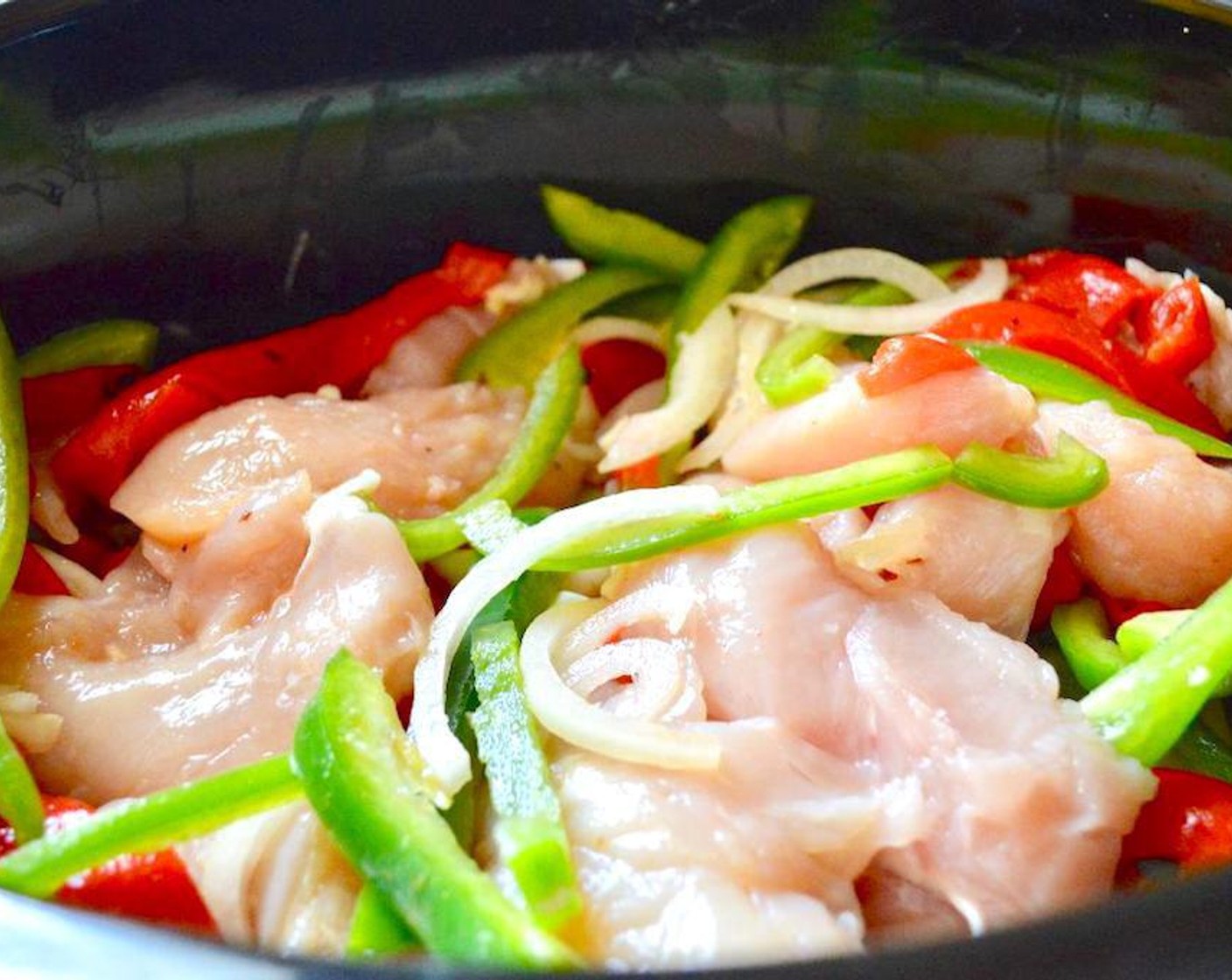step 1 Combine the Chicken Tenders (2 lb), Jarred Roasted Red Peppers (2 jars), Green Bell Peppers (2), Onions (2), Garlic (3 cloves), Worcestershire Sauce (1/2 tsp), Beer (1/2 cup), Chicken Stock (1/2 cup), Ground Cumin (1/2 tsp), Paprika (1/2 tsp), Salt (1/2 tsp), and Crushed Red Pepper Flakes (1/2 tsp) in a large slow cooker.
