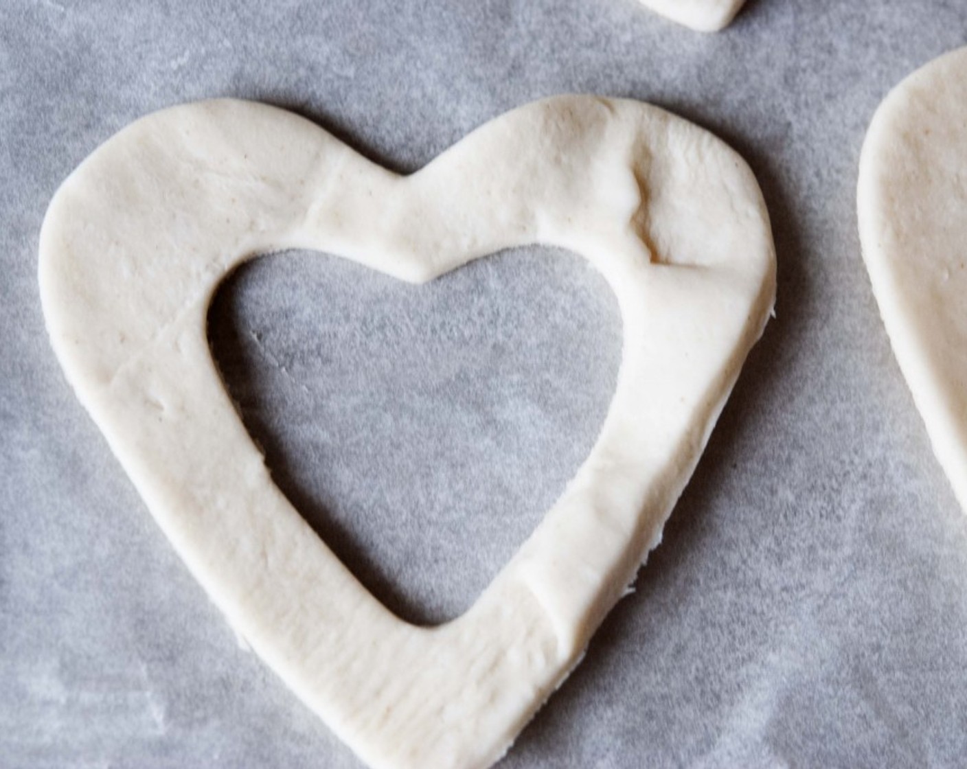 step 13 Now on to the heart-shaped vol-au-vents! Roll out the second sheet of puff pastry and using cookie cutters, cut out hearts. Put together the Egg (1) and the Milk (2 Tbsp) to make the egg-milk wash.