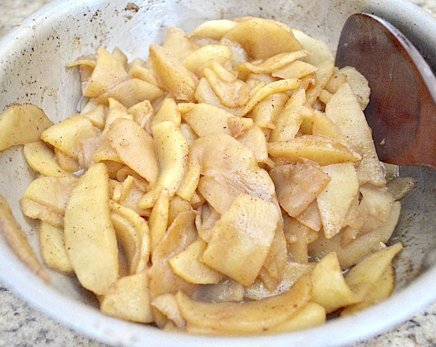 step 9 While it bakes, make the filling. Melt the Butter (4 Tbsp) in the same pan you used for the brown butter. Add the Gala Apples (6), Dark Brown Sugar (4 Tbsp), Orange Juice (2 Tbsp) and Simply Organic Cinnamon, Ground (1 tsp). Let it all gently simmer for about 15 minutes to bring out the flavors and cook off almost all of the liquid.