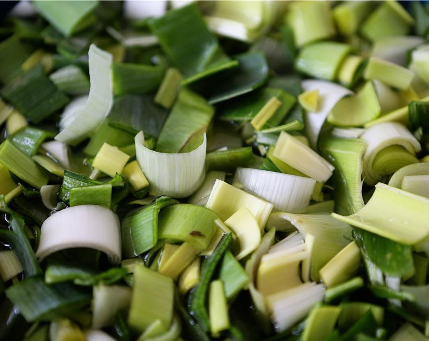 step 2 While walnuts are toasting, remove the root from Leeks (4) with a chef's knife, and cut the remaining portion in half. Slice leeks into 1/2 inch pieces. Place in a small bowl, and submerge in water. Agitate leeks to remove dirt.