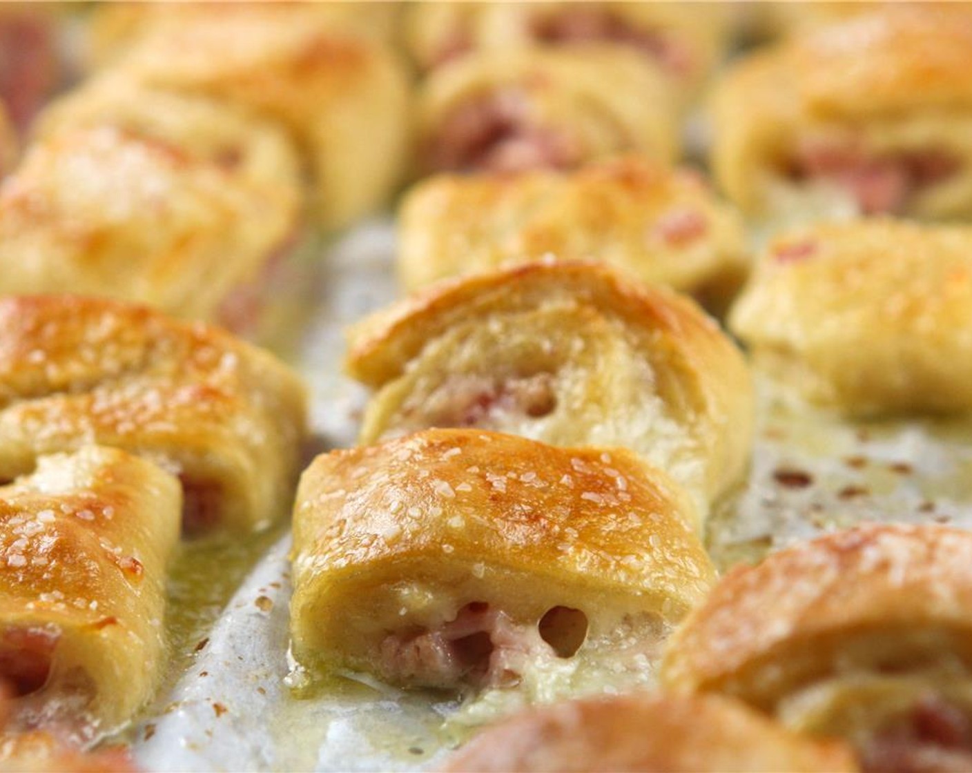 step 11 Bake until puffed and golden-brown, about 15 minutes. Brush warm pretzel bites with melted butter and sprinkle with Kosher Salt (1 Tbsp).