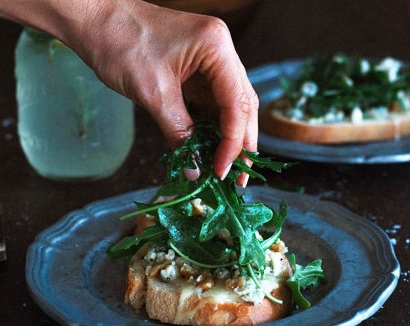 step 6 Top each bruschetta with a handful of arugula.