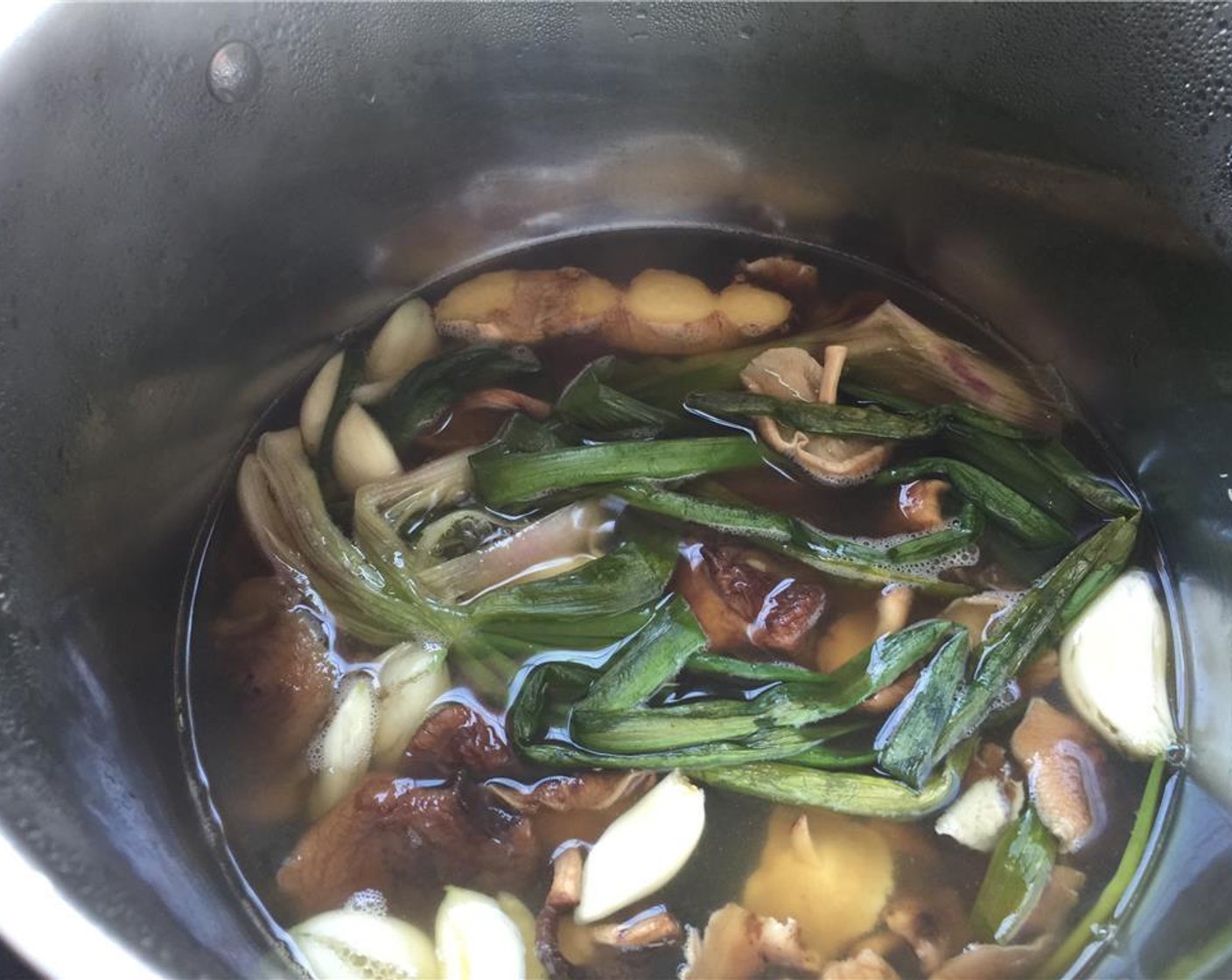 step 4 Add the Vegetable Stock (12 cups) to a pot and add in the kombu, spring onions, Dried Shiitake Mushroom (3/4 cup), ginger and garlic and bring to a slow simmer for an hour and a half to make the dashi.