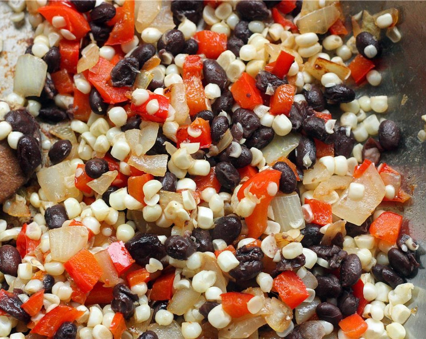 step 8 Add black beans and corn to the onion and pepper mixture and sauté for 2-3 minutes more.
