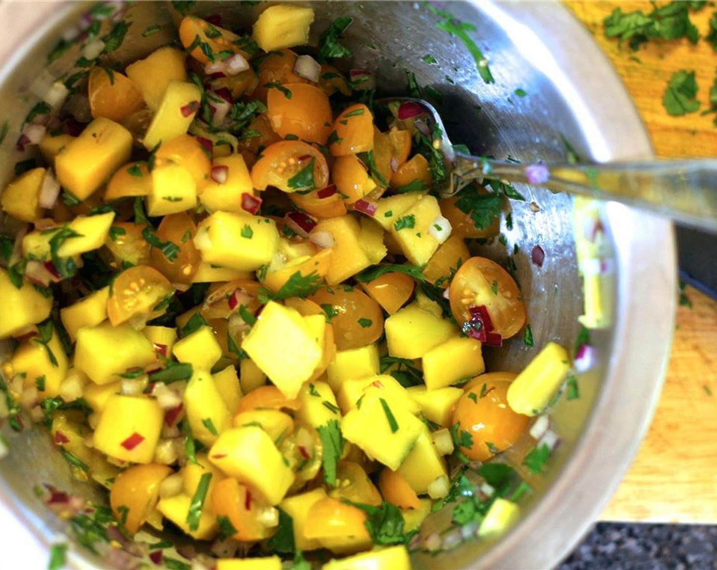 step 4 Prepare the mango salsa by combining the Mango (1), Yellow Cherry Tomato (1 cup), Fresh Cilantro (2 Tbsp), Red Onions (2 Tbsp), Fresh Ginger (1/2 tsp), Lime (1), and Salt (1/2 tsp) in a bowl. Set aside to let those flavors mingle.