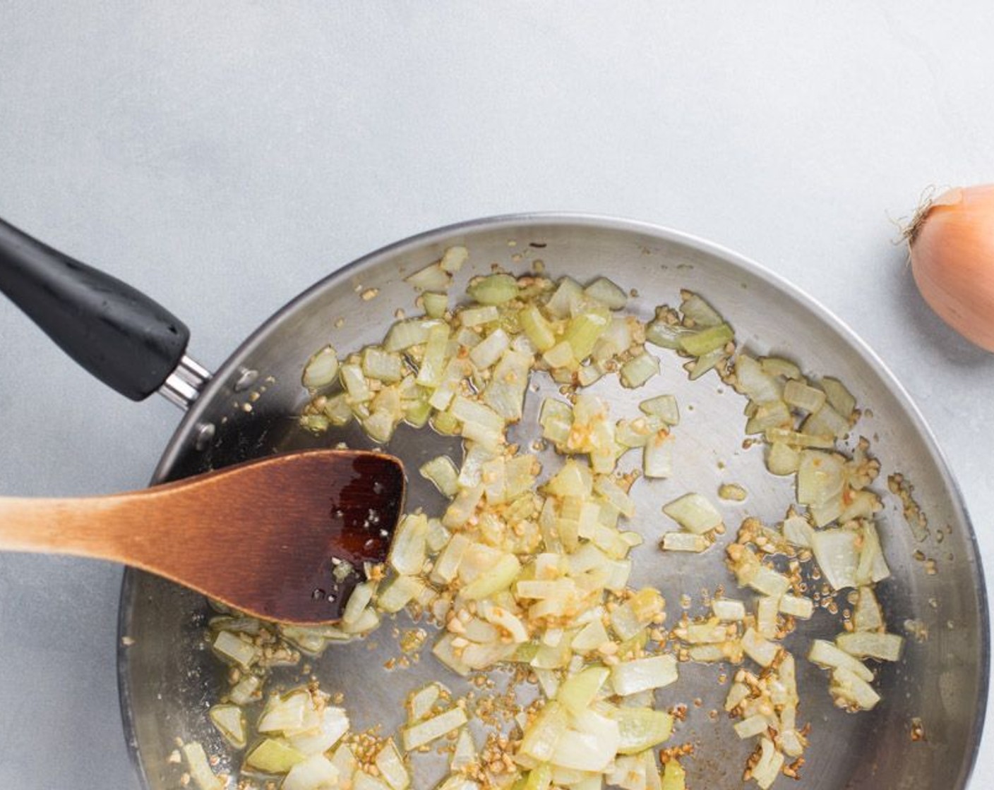 step 2 Heat a large skillet to medium high heat, adding the Extra-Virgin Olive Oil (4 Tbsp) to the pan. Saute the Onion (1) and Garlic (2 Tbsp) until softened, 2-3 minutes. Stir frequently.