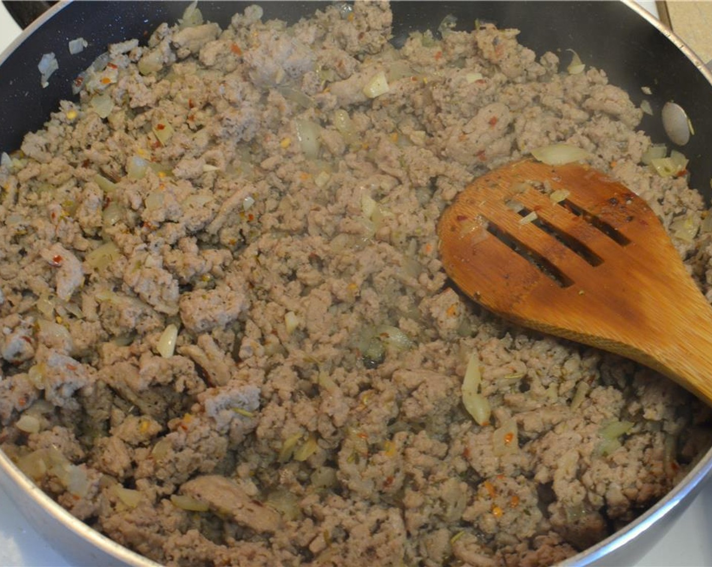 step 4 Season the meat with Salt (to taste), Ground Black Pepper (to taste), Italian Seasoning (2 Tbsp) and Crushed Red Pepper Flakes (1 tsp) for heat, and let the meat cook and brown.