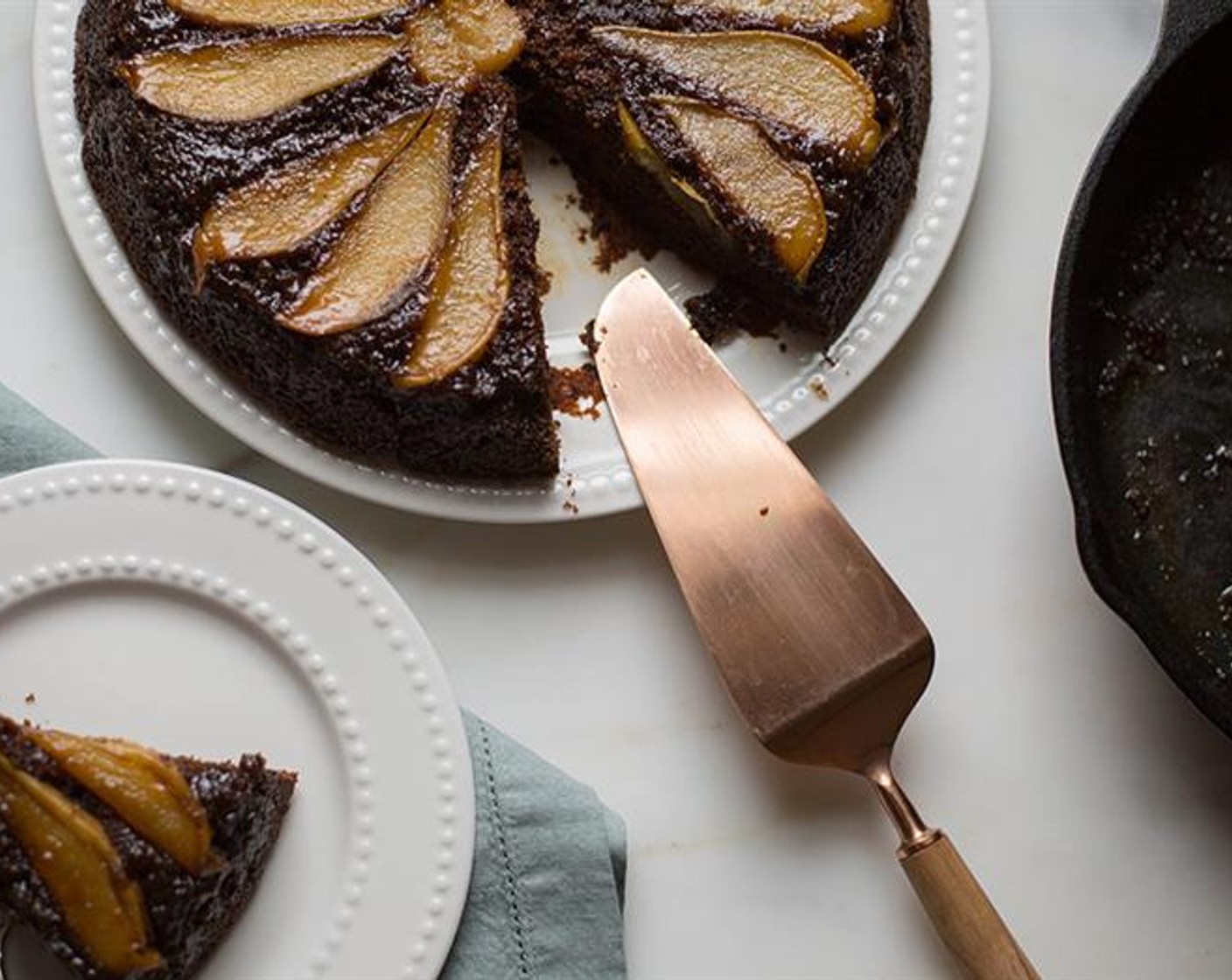 step 8 Place a large plate or serving board over the skillet and using potholders, carefully invert the cake onto the plate. Serve warm or at room temperature. Enjoy!