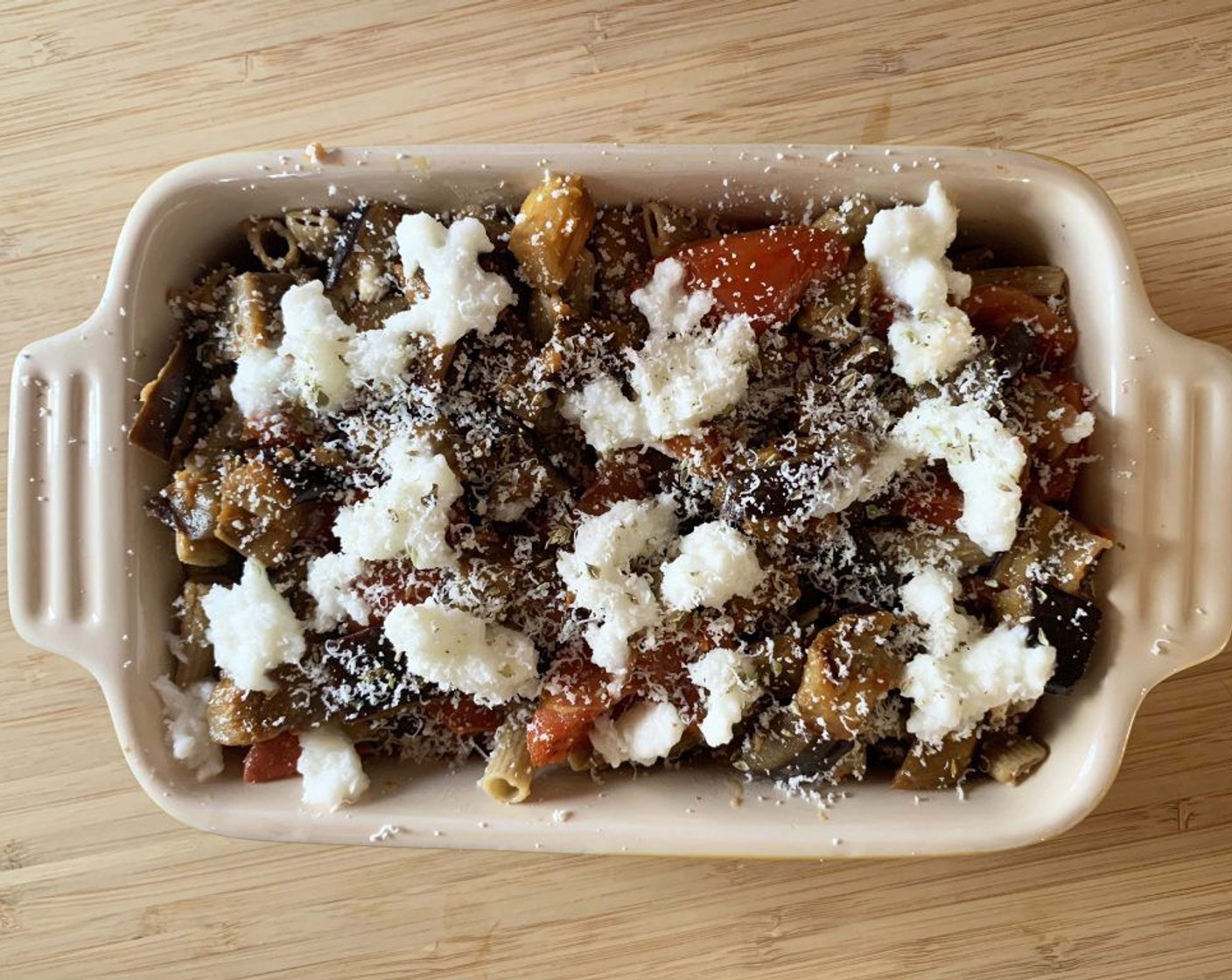 step 9 Transfer into a baking dish, grate some Nutritional Yeast (2 Tbsp) if you prefer. Cover with the remaining 1/3 of sauce and Vegan Cheese (3 Tbsp).