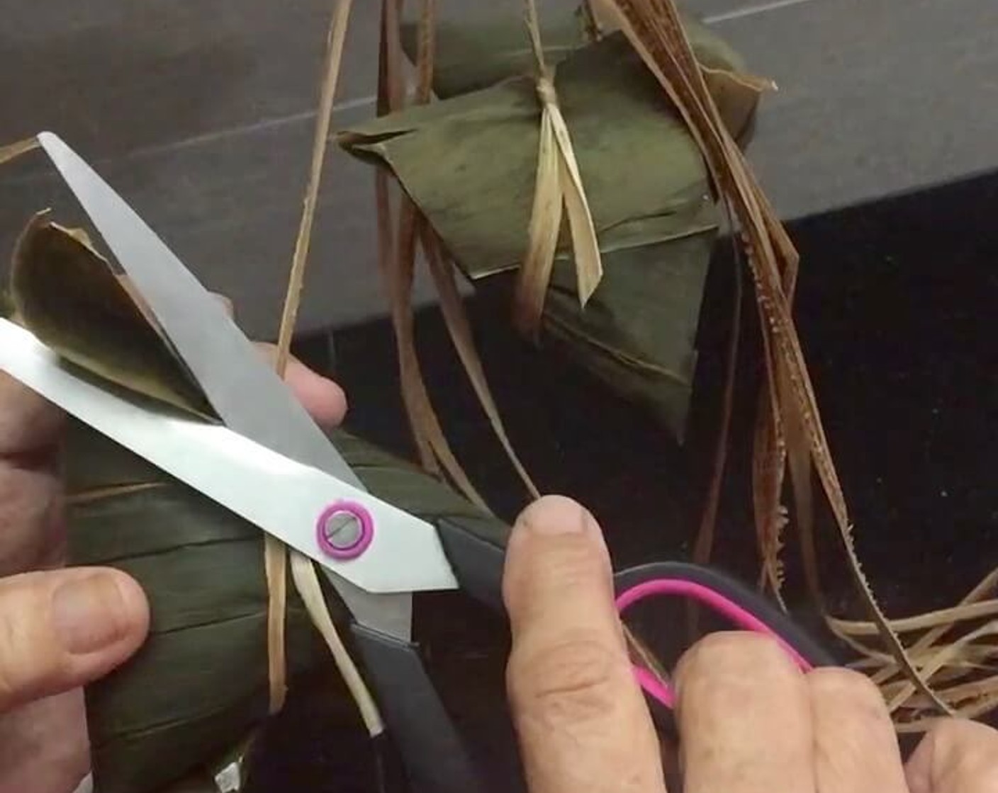 step 38 Snip off excess bamboo leaves and strings. And we're ready to cook the sticky rice dumplings.